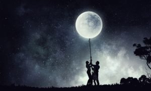 a small group of people holding up the moon
